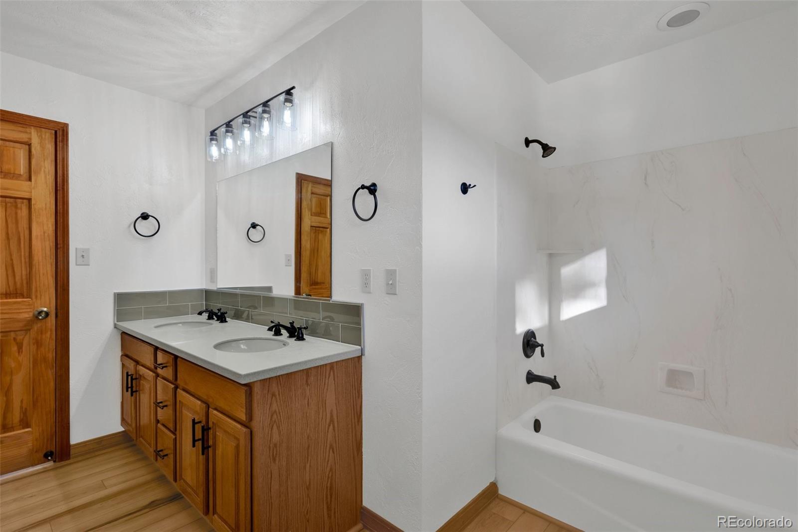 820 Schulze Ranch Road Westcliffe, CO 81252 - Photo 17 of 39 a bathroom with a sink a mirror and a bathtub