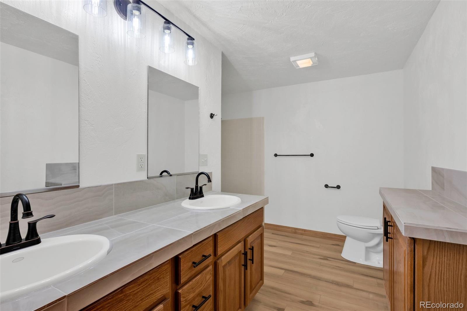820 Schulze Ranch Road Westcliffe, CO 81252 - Photo 25 of 39 a bathroom with a sink and a mirror