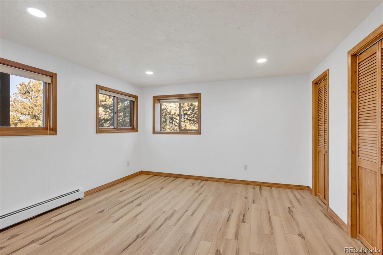 820 Schulze Ranch Road Westcliffe, CO 81252 - Photo 26 of 39 a view of empty room with wooden floor and fan