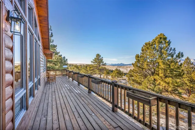 a view of a balcony with wooden floor and city view