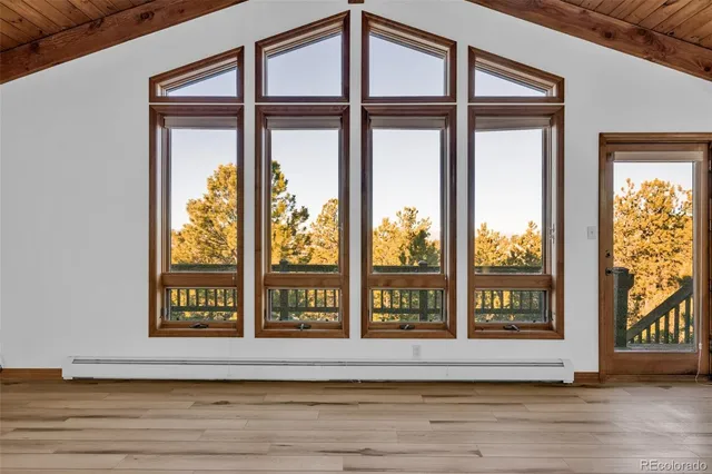 a large kitchen with stainless steel appliances granite countertop a lot of counter space and wooden floor