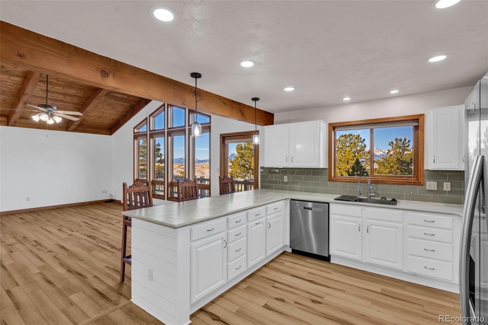 820 Schulze Ranch Road Westcliffe, CO 81252 - Photo 10 of 39 a large kitchen with stainless steel appliances granite countertop a lot of counter space and wooden floor