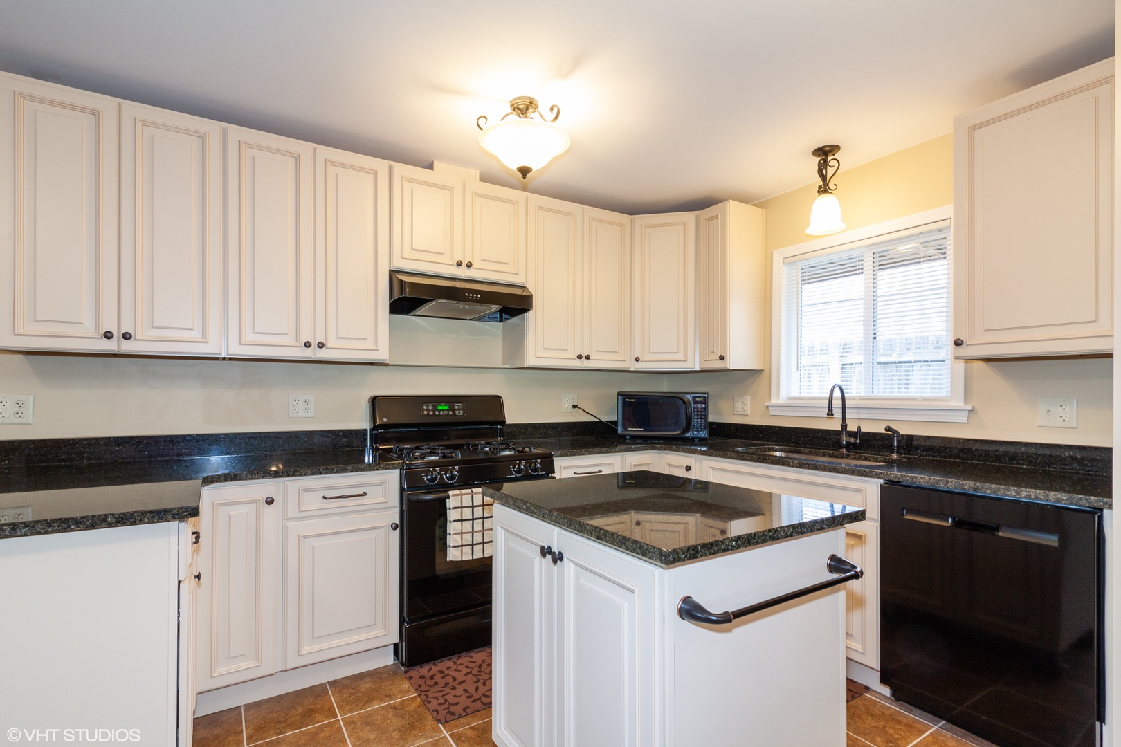 104 South Pinecrest Road Bolingbrook, IL 60440 - Photo 3 of 12 a kitchen with granite countertop white cabinets and a stove a sink with dishwasher