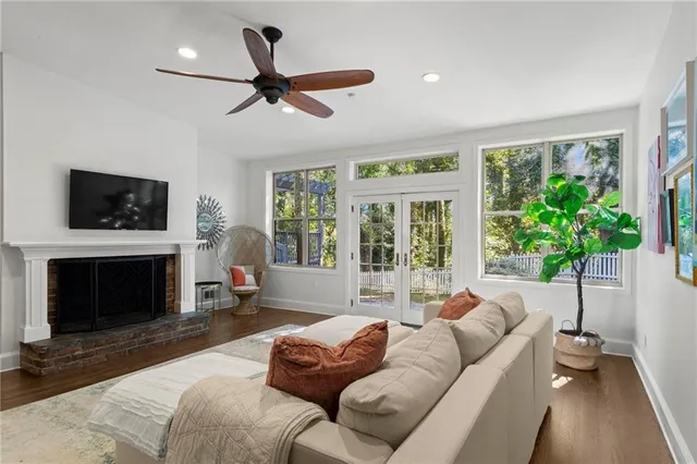 a living room with furniture a flat screen tv and a fireplace