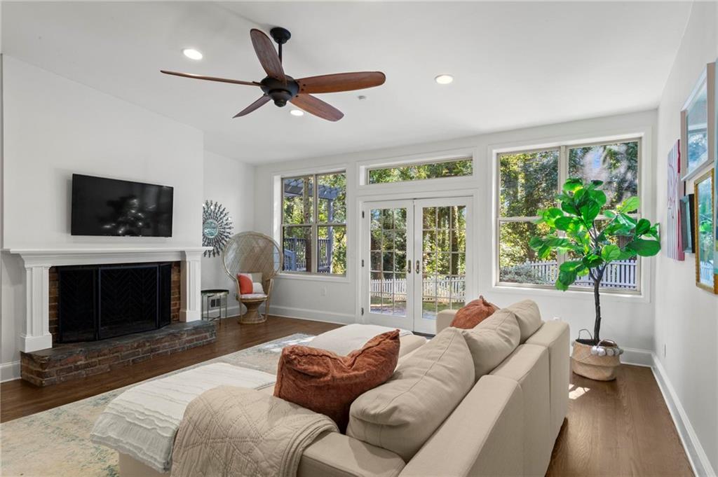 a living room with furniture a flat screen tv and a fireplace