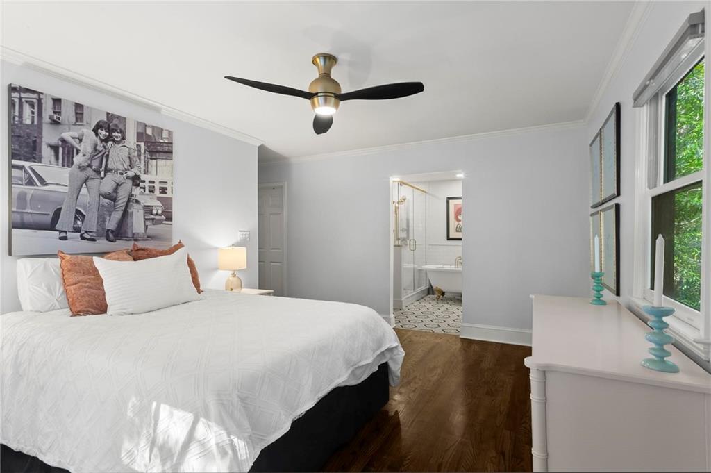 1788 Moores Mill Road Northwest Atlanta, GA 30318 - Photo 17 of 25 a bedroom with a bed and a flat screen tv