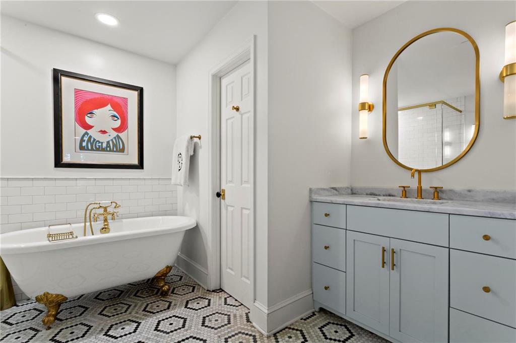 1788 Moores Mill Road Northwest Atlanta, GA 30318 - Photo 19 of 25 a bathroom with a sink and mirror
