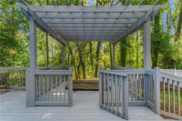 a view of porch with green trees in front of it