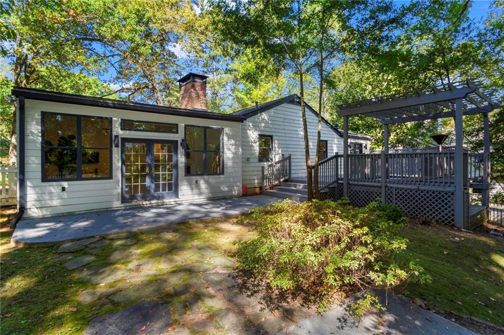 1788 Moores Mill Road Northwest Atlanta, GA 30318 - Photo 24 of 25 a view of a house with backyard and sitting area