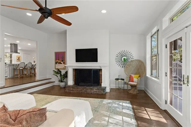 a living room with furniture a fireplace and a flat screen tv