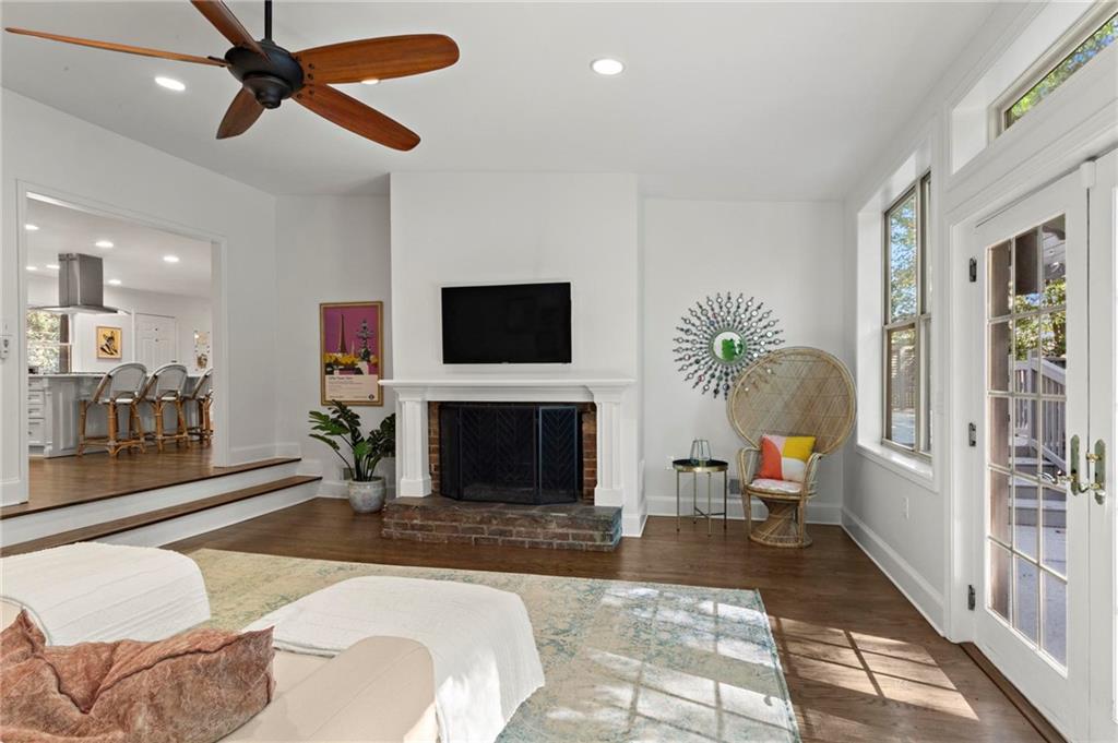 1788 Moores Mill Road Northwest Atlanta, GA 30318 - Photo 3 of 25 a living room with furniture a fireplace and a flat screen tv