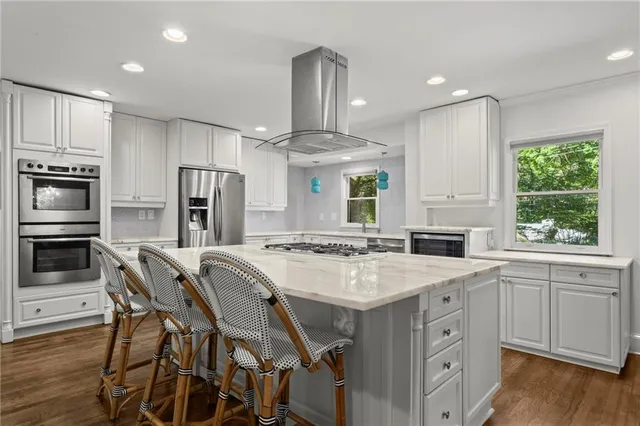 a kitchen with a stove a refrigerator and a sink