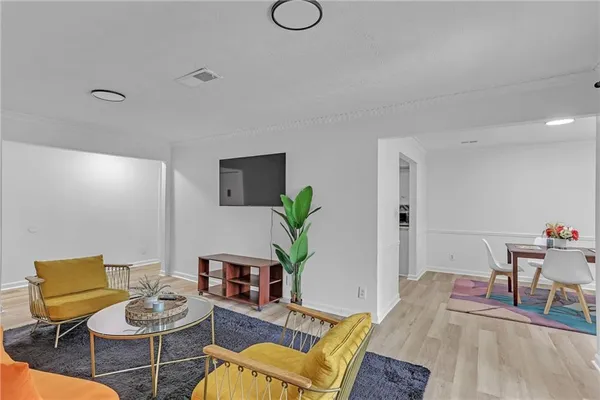 a living room with furniture and wooden floor