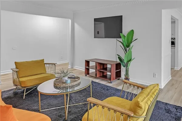a living room with furniture a potted plant and a lamp