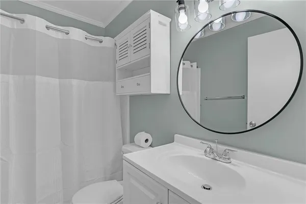 a bathroom with a sink toilet and mirror