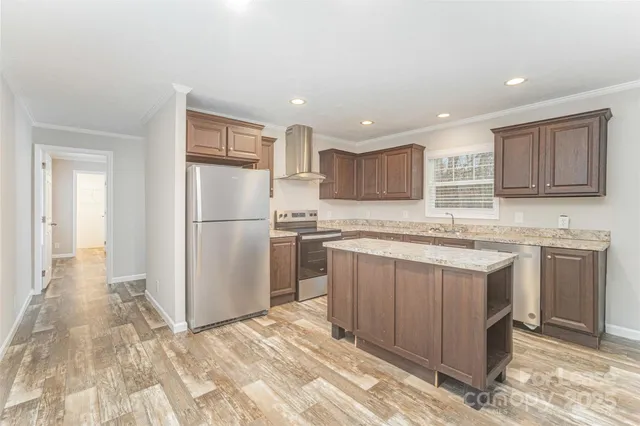 a kitchen with a refrigerator sink and cabinets