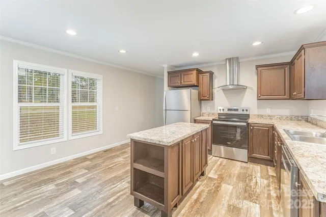 a kitchen with a stove a sink and a refrigerator