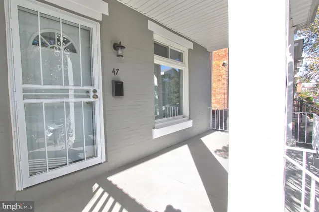 a view of a bedroom with wooden floor and windows