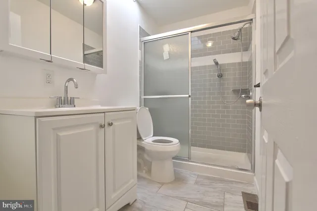 a view of an empty room with a chandelier fan