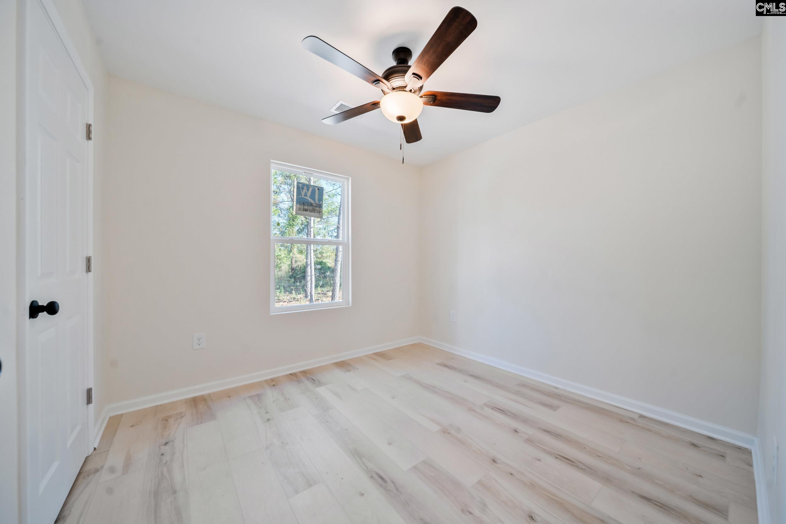 116 Sunny Acres Road Eastover, SC 29044 - Photo 14 of 40 an empty room with a window and a fan