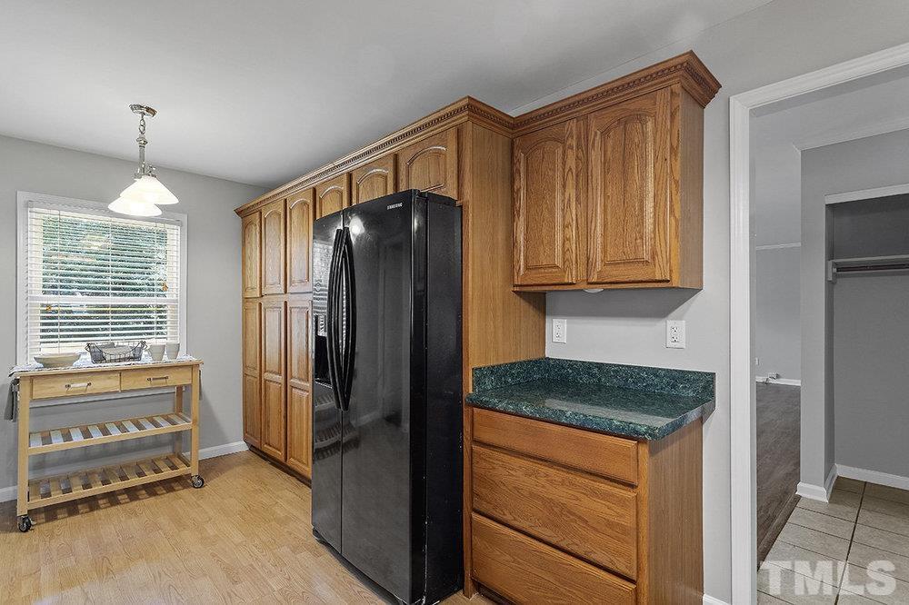 3304 Blue Ridge Road Raleigh, NC 27612 - Photo 11 of 34 a kitchen with stainless steel appliances granite countertop a refrigerator and a stove