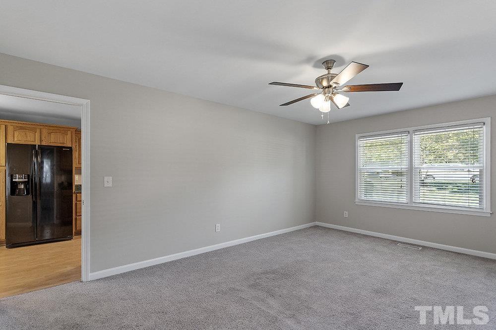 3304 Blue Ridge Road Raleigh, NC 27612 - Photo 14 of 34 an empty room with chandelier fan and windows
