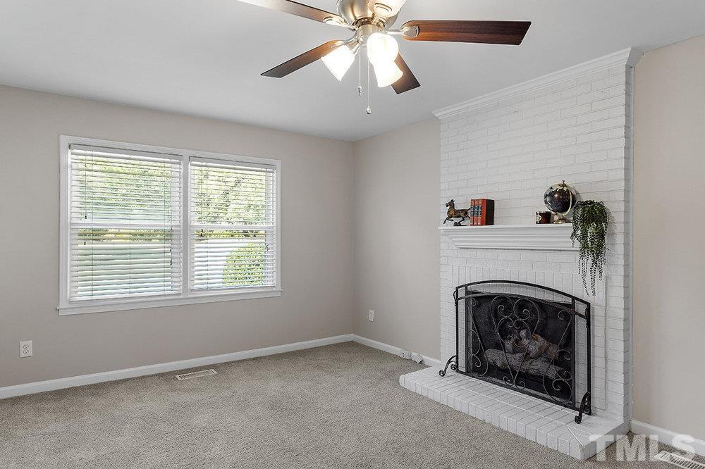 3304 Blue Ridge Road Raleigh, NC 27612 - Photo 15 of 34 a view of empty room with fireplace and fan