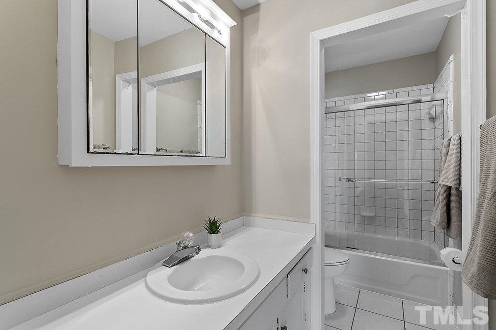 3304 Blue Ridge Road Raleigh, NC 27612 - Photo 20 of 34 a bathroom with a sink shower and a mirror