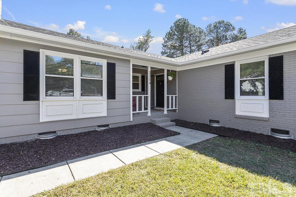 3304 Blue Ridge Road Raleigh, NC 27612 - Photo 2 of 34 a view of house with backyard