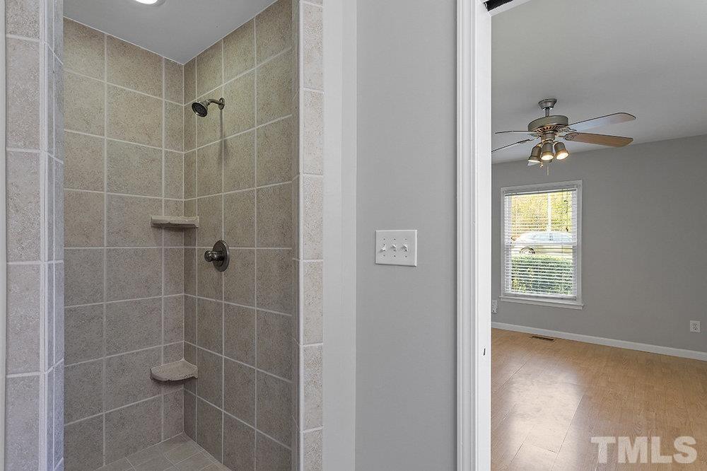 3304 Blue Ridge Road Raleigh, NC 27612 - Photo 27 of 34 a bathroom with a light fixture a sink and a window