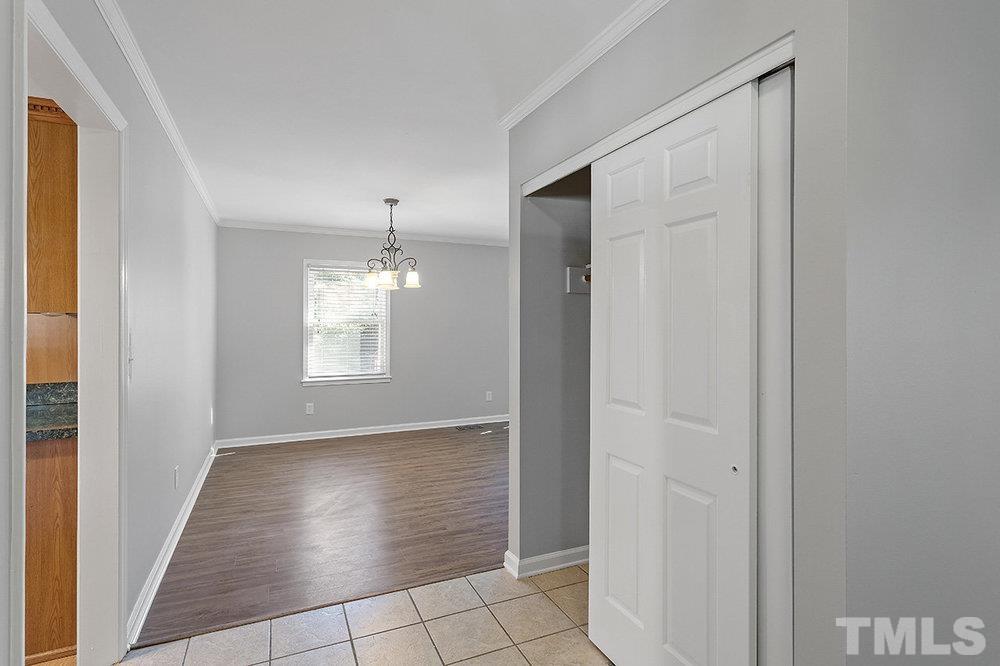3304 Blue Ridge Road Raleigh, NC 27612 - Photo 3 of 34 a view of an empty room with window and wooden floor