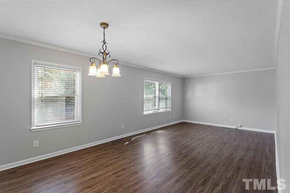 3304 Blue Ridge Road Raleigh, NC 27612 - Photo 5 of 34 an empty room with wooden floor and windows
