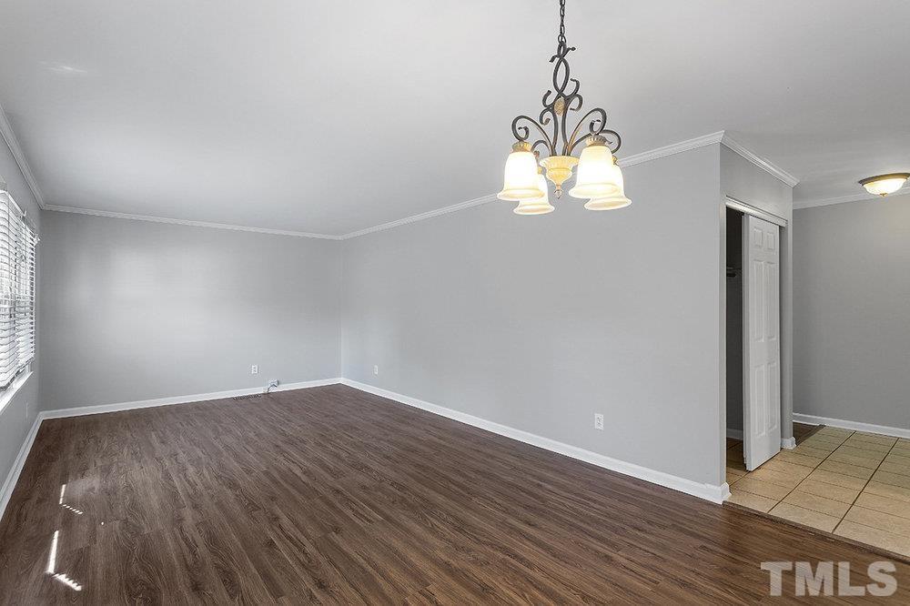 3304 Blue Ridge Road Raleigh, NC 27612 - Photo 6 of 34 an empty room with wooden floor and windows