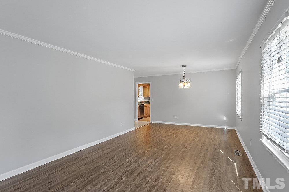 3304 Blue Ridge Road Raleigh, NC 27612 - Photo 8 of 34 an empty room with wooden floor and windows