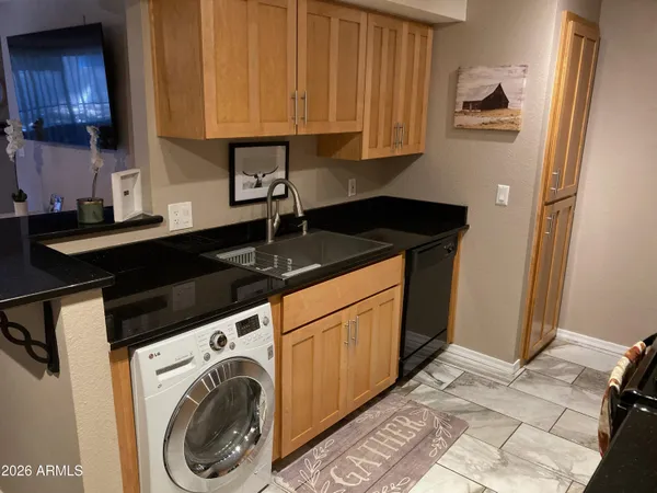 a kitchen with stainless steel appliances granite countertop a sink stove and cabinets