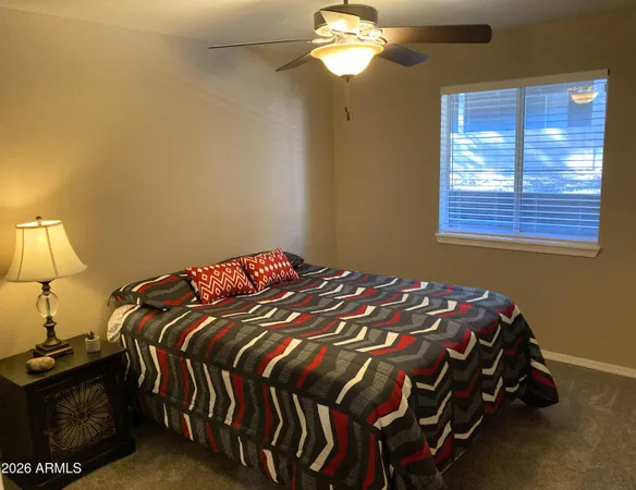 a bedroom with a bed and a lamp