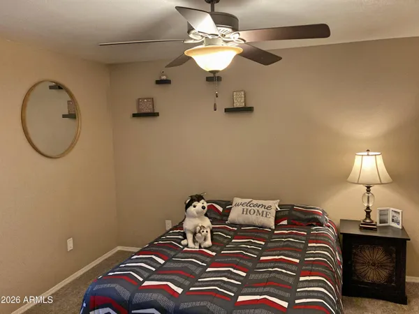 a bedroom with a bed and a chandelier