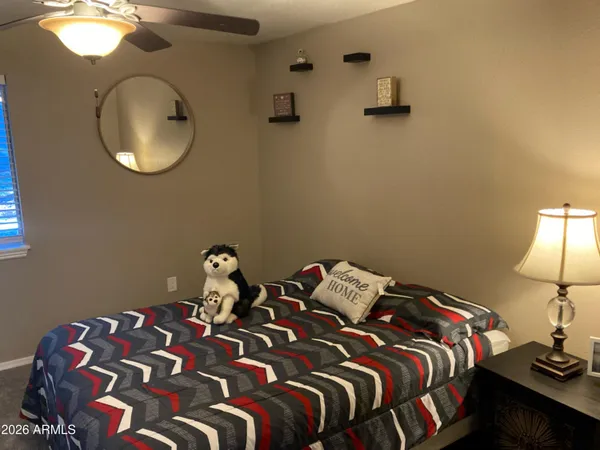 a bedroom with a bed and a lamp