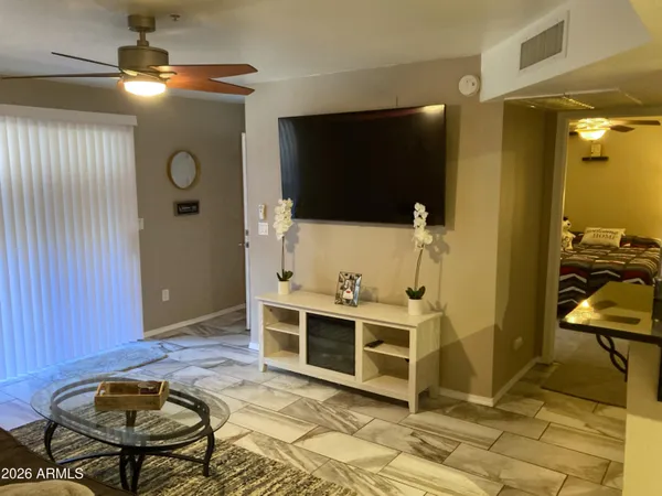 a view of a livingroom with furniture and a flat screen tv