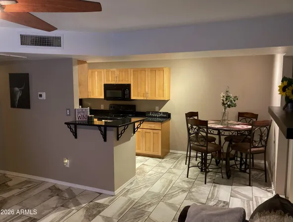 a kitchen with a table chairs stove and microwave