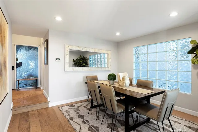 a dining room with furniture and wooden floor