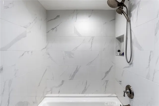 a bedroom with a bed couch and a window