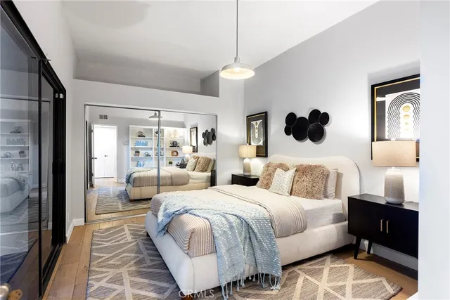 a bedroom with a large bed and a large mirror