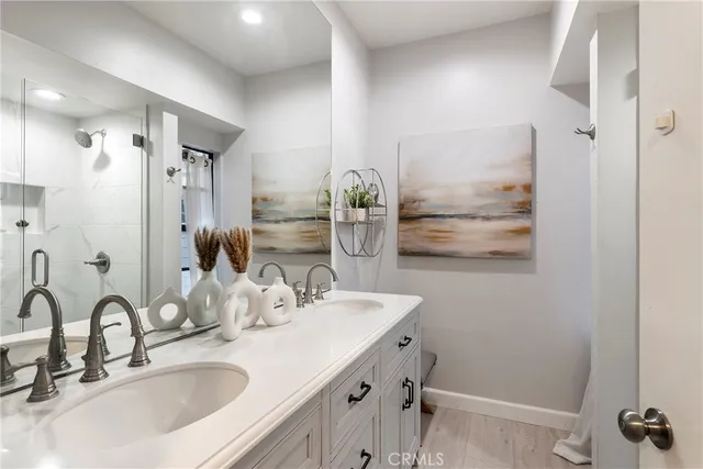 a bedroom with a bed and a lamp on dresser