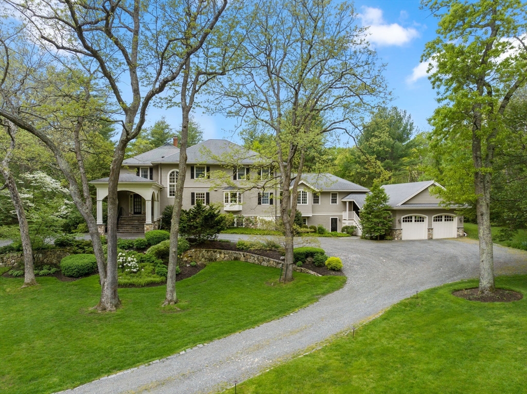 134 Dedham Street Dover, MA 02030 - Photo 1 of 42 a front view of a house with a yard table and chairs