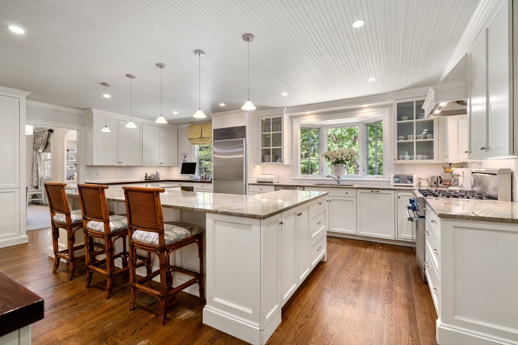 134 Dedham Street Dover, MA 02030 - Photo 12 of 42 a kitchen with a sink cabinets and wooden floor