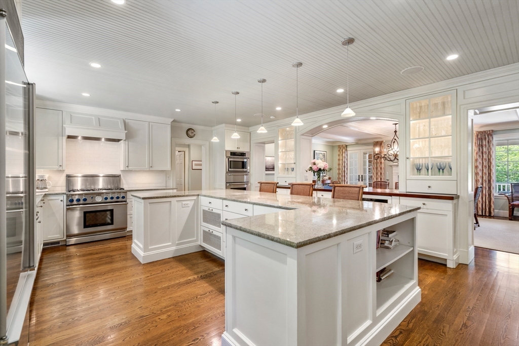 134 Dedham Street Dover, MA 02030 - Photo 13 of 42 a kitchen with stainless steel appliances kitchen island granite countertop a large center island and a stove