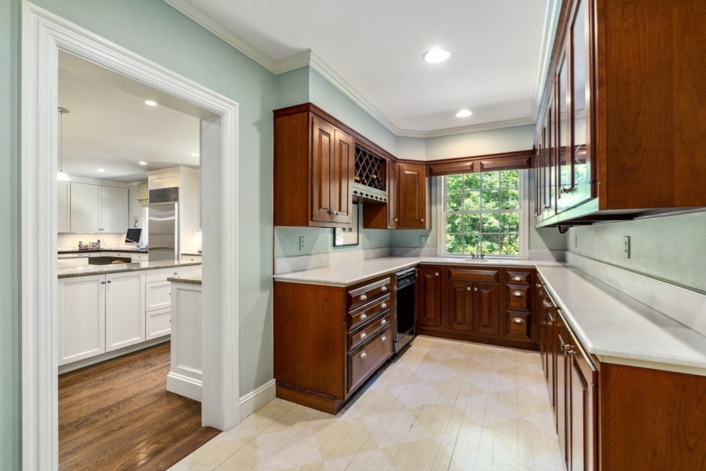134 Dedham Street Dover, MA 02030 - Photo 16 of 42 a kitchen with stainless steel appliances granite countertop a refrigerator a sink and wooden cabinets