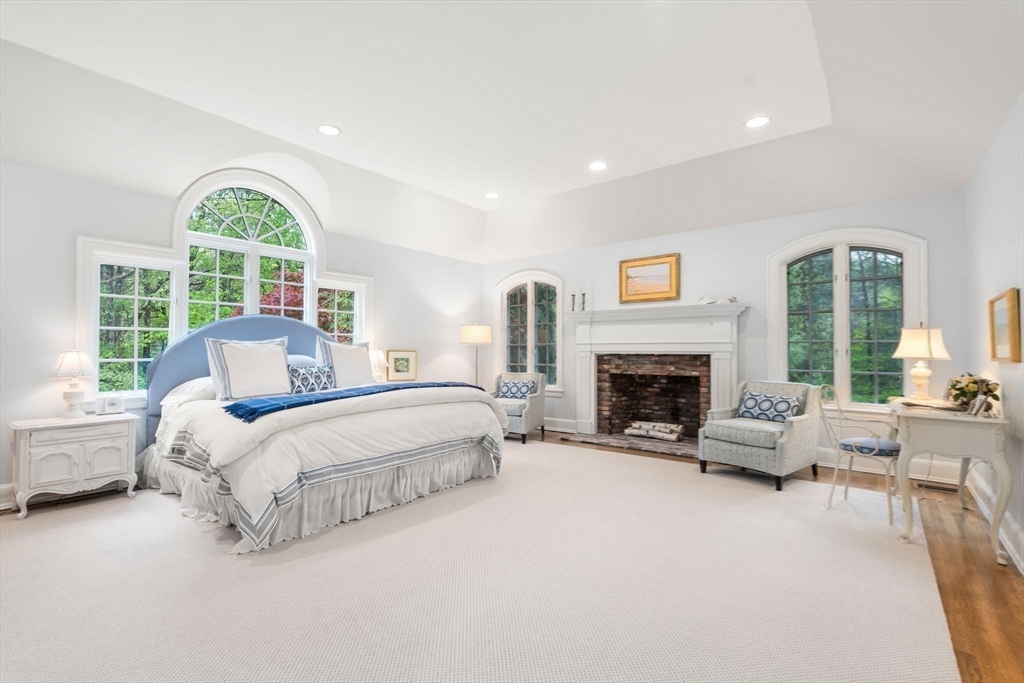 134 Dedham Street Dover, MA 02030 - Photo 20 of 42 a spacious bedroom with a bed and a large window