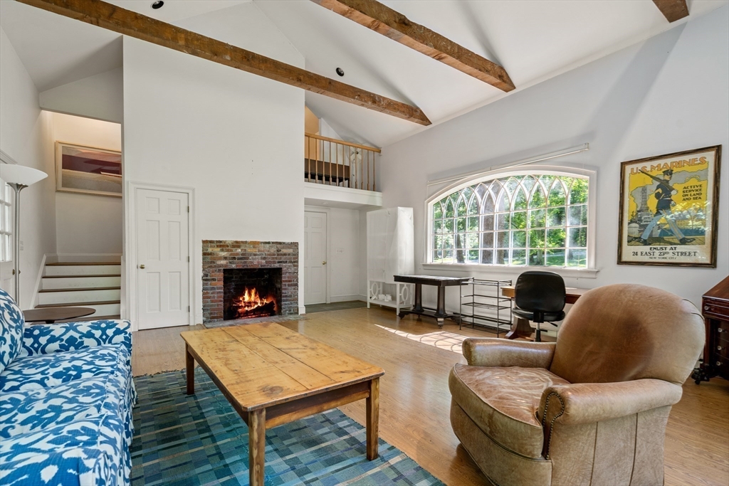 134 Dedham Street Dover, MA 02030 - Photo 34 of 42 a living room with furniture and a fireplace